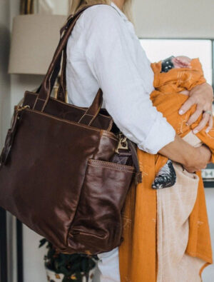 Woman holding Thandana Noa leather baby changing bag